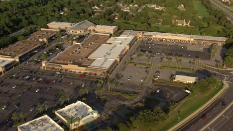 drone view panning left over highway 98 in destin florida with a view of silver sands outlet mall