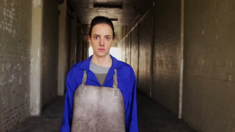 female welder walking in workshop