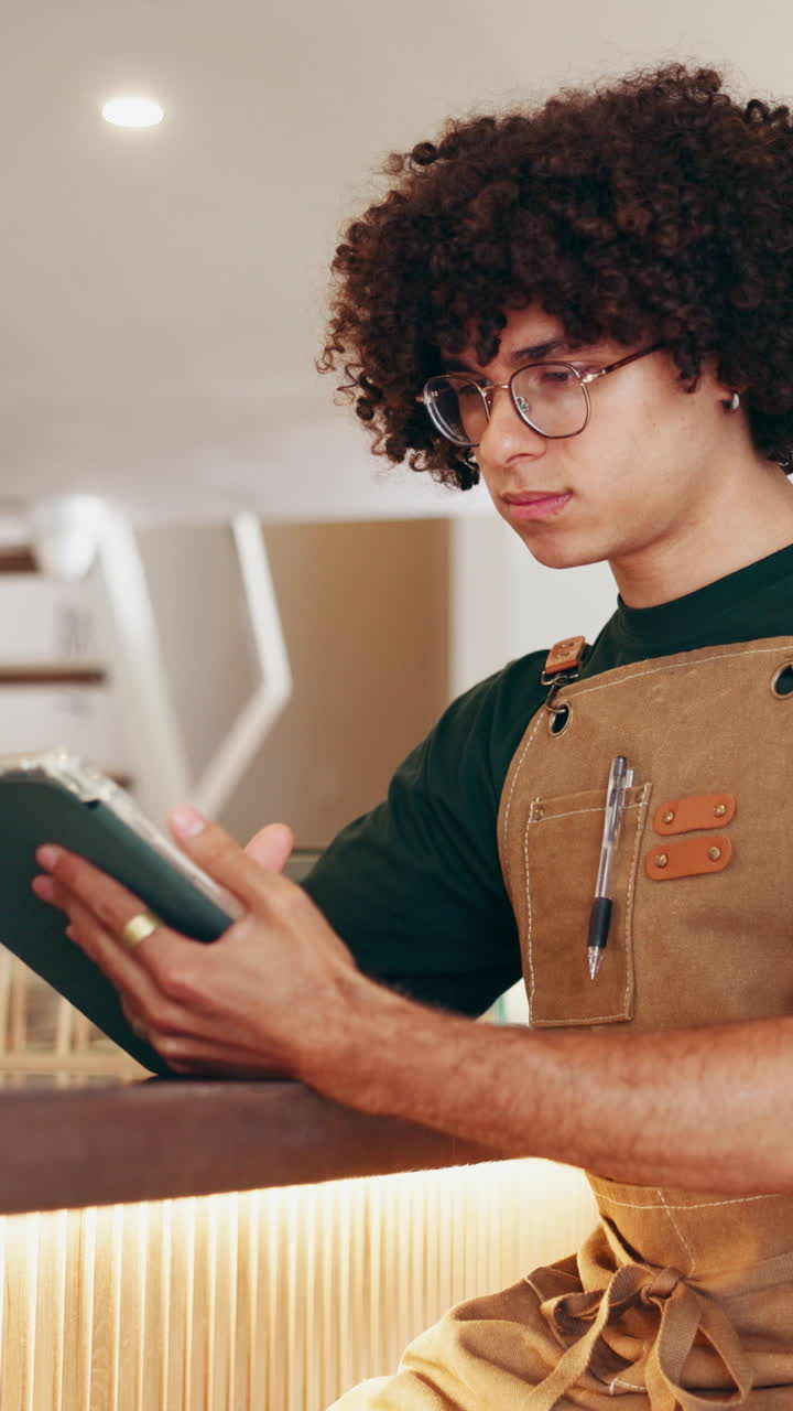 Man with curly hair wearing an apron