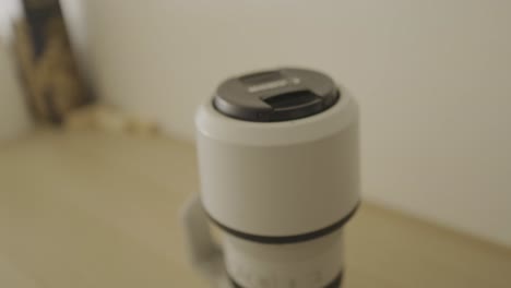 camera lens rotating on a wooden desk