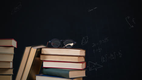 eyeglass on a pile of books and mathematical equations with figures