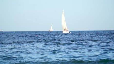 yacht with people swiming on the waves