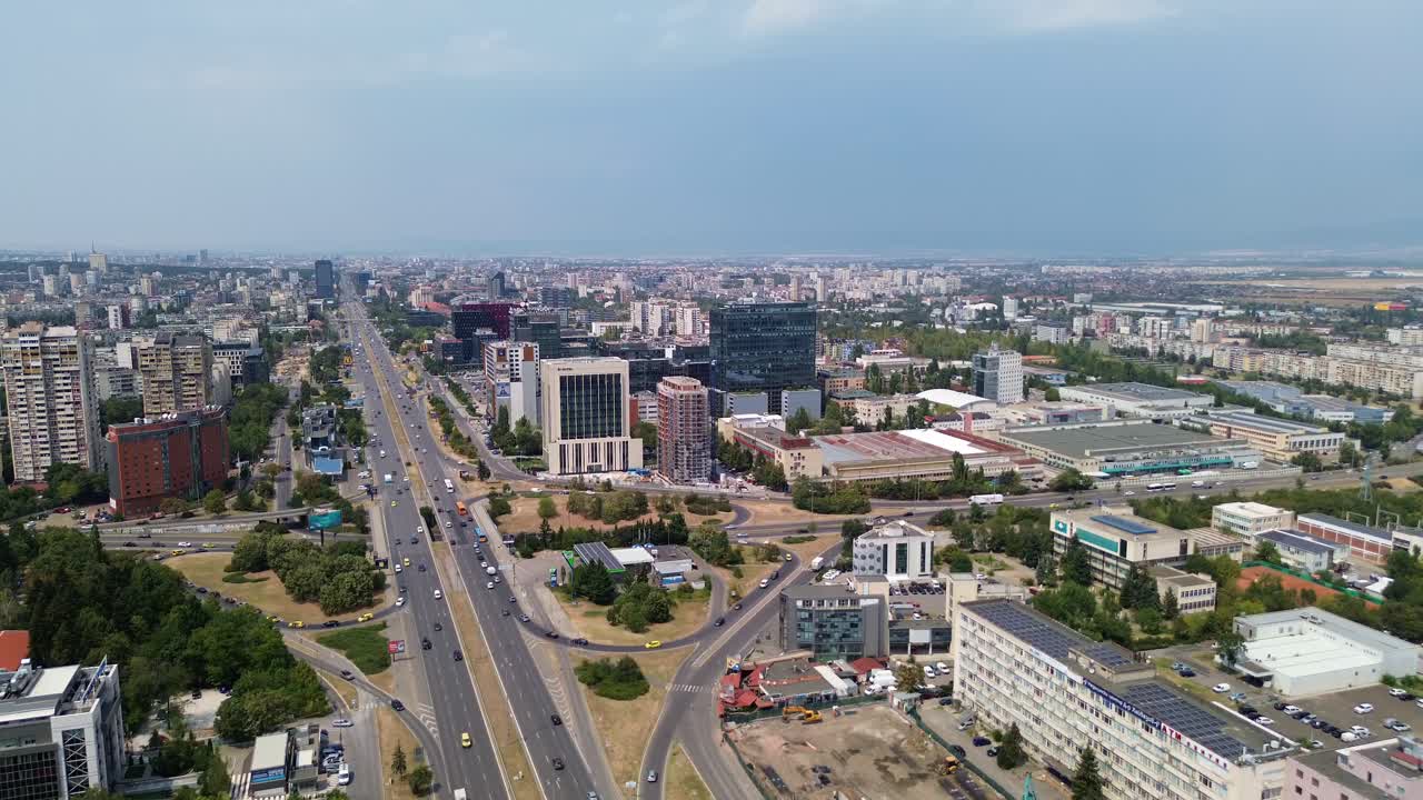 drone shot, rising above Sofia, the capital city of Bulgaria, on a rainy summer day with a with the traffic on Tsarigradsko shose blvd below