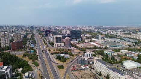drone shot, rising above sofia, the capital city of bulgaria, on a rainy summer day with a with the traffic on tsarigradsko shose blvd below