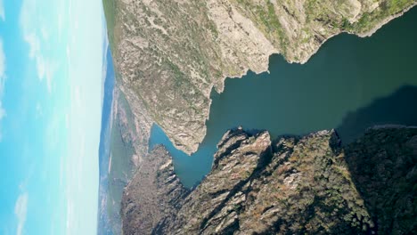 Aerial pan across stunning green and blue Sil river Canyon of spain, vertical