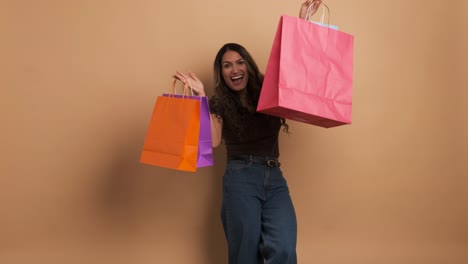 happy woman showing and holding many shopping bags