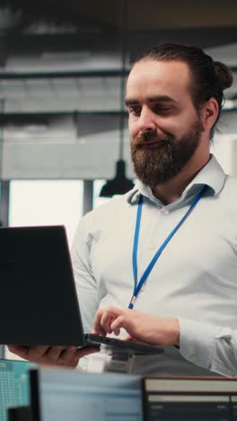 vertical video male boss strategizes in a modern workplace surrounded by colleagues