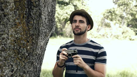 In-high-quality-format-handsome-hipster-using-vintage-camera