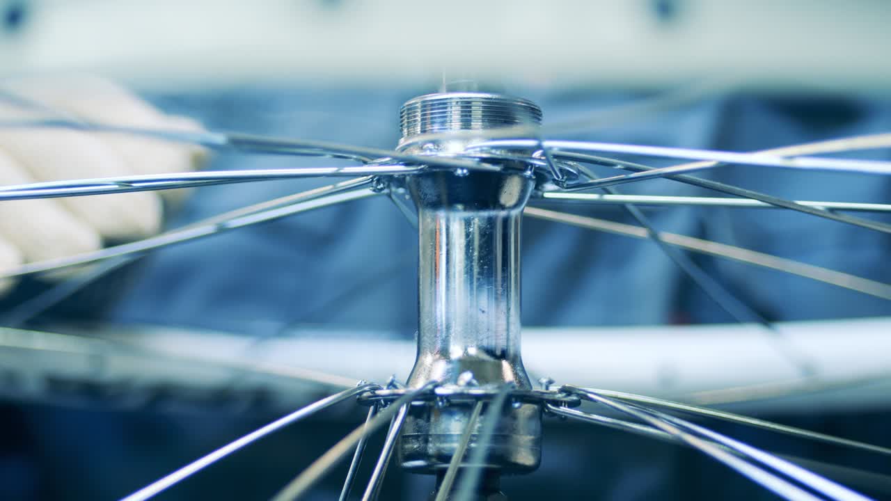 Close up shot of a factory worker building a bicycle rim