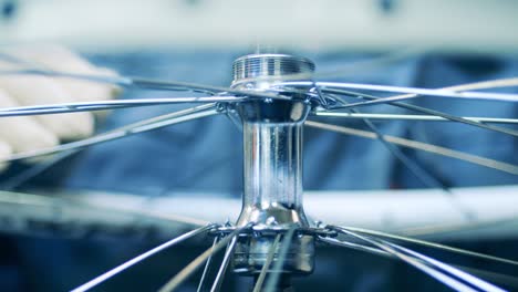 close up shot of a factory worker building a bicycle rim