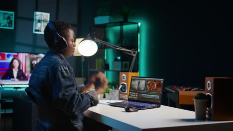 young person editing a video at night