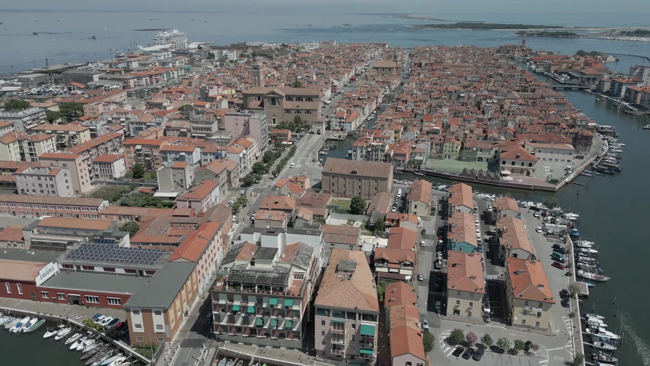 Vista aerea di Chioddia, Italia, circondata dall'acqua in una giornata di sole.