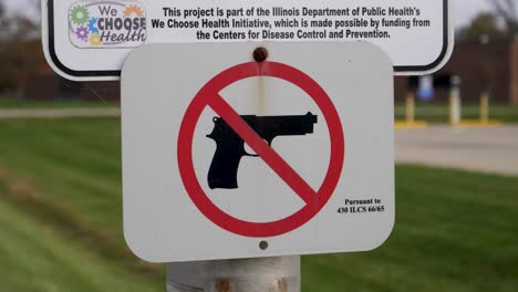 no handguns signage shown in close up to highlight the warning issued by the community college