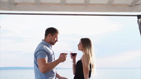 couple enjoying wine by the lake