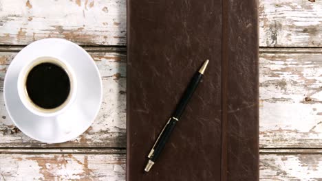 diary with pen, cup of coffee and smartphone