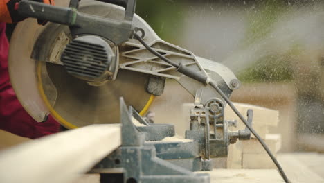 slow motion close up of table saw cutting wood on construction site