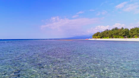 stunning aerial footage of the gili islands, indonesia. crystal-clear waters, white sand beaches, coral reefs, and boats in paradise. ideal for travel, nature, and tropical themes