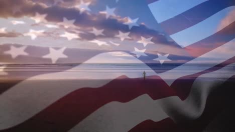 Digital-composition-of-waving-us-flag-against-man-walking-on-the-beach