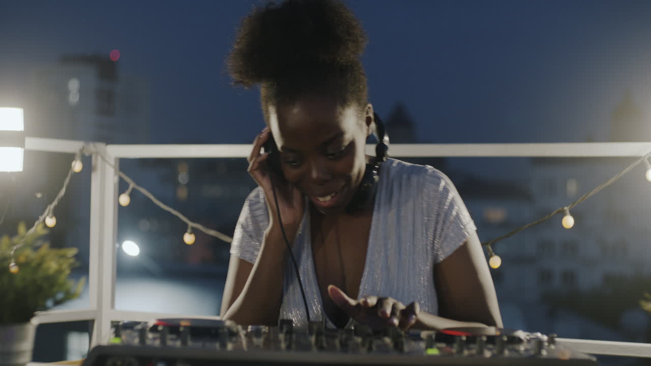 DJ on a Rooftop at Night