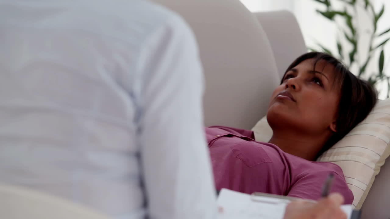 Patient lying on sofa in therapy