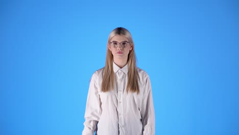 Blonde-Young-Caucasian-Student-Smart-Look-Woman-Plays-with-a-Red-Apple-in-Studio