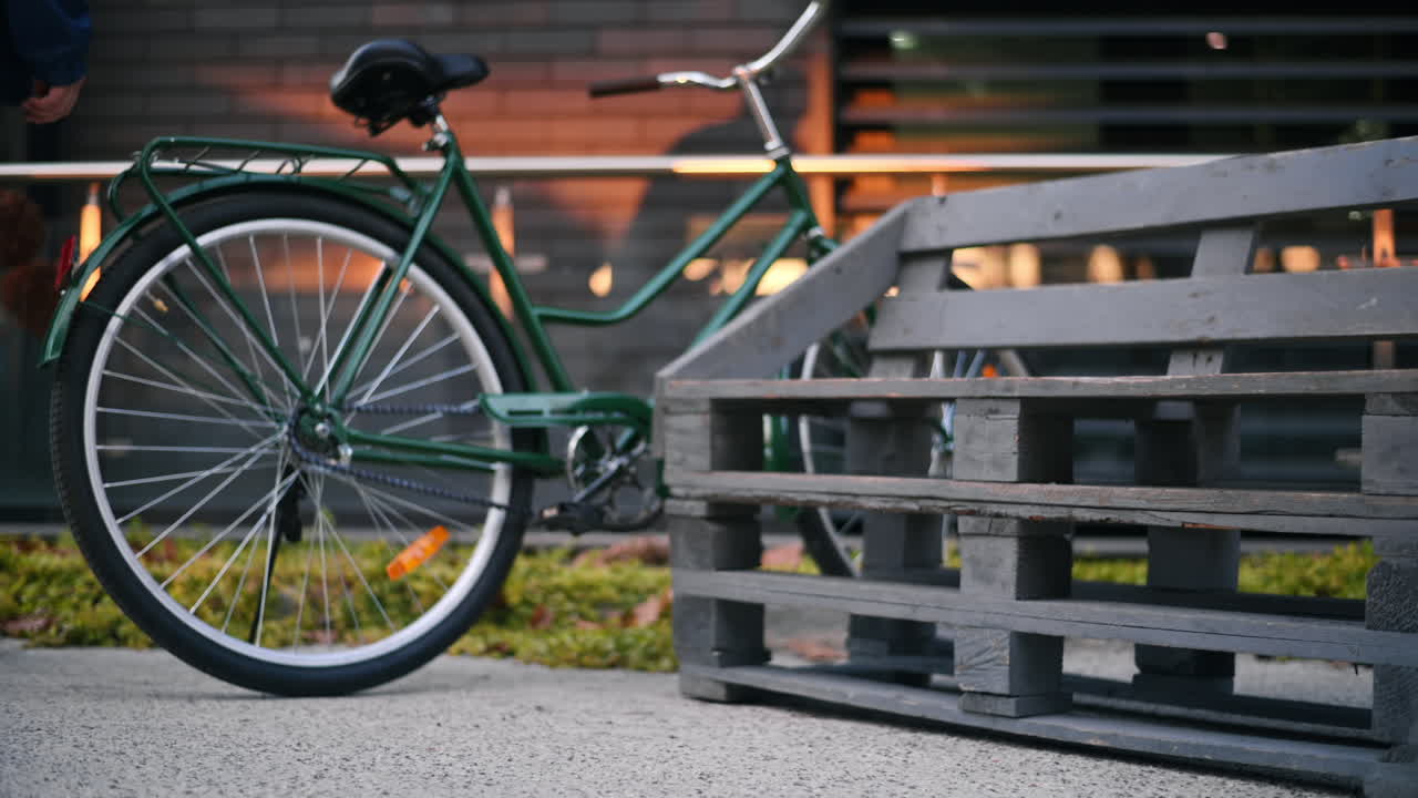 View of a man with prosthetic legs. Getting up from the bench and leaving with his bicycle