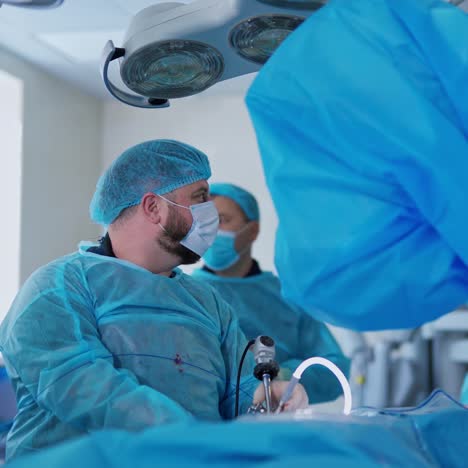 surgery with special medical equipment. doctors in medical uniform doing kidney operation in modern clinic. innovative medicine.