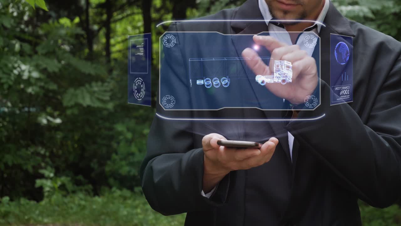 사업가가 트럭 타이어와 함께 홀로그램을 사용합니다.