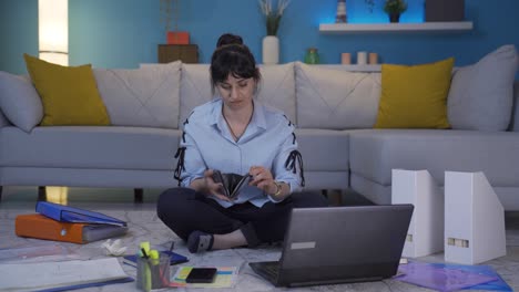 Home-office-worker-woman-showing-her-empty-wallet-to-the-camera.