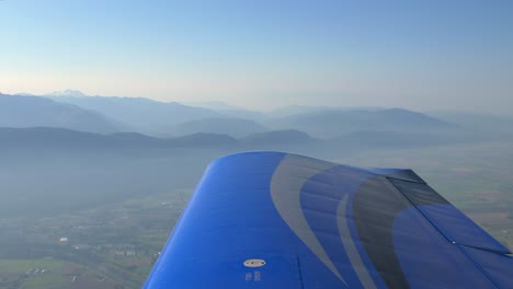 view of wing of light airplane in flight producing lift