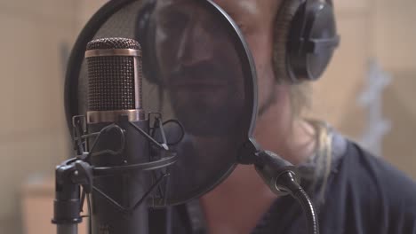 Extreme-closeup-of-condenser-microphone-and-singers-mouth-and-lips