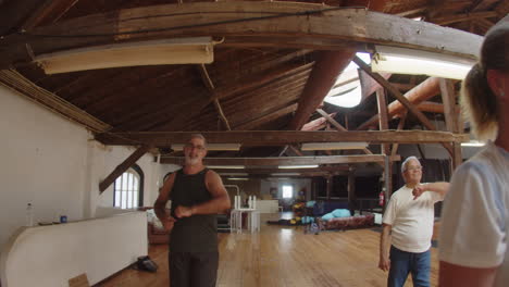 long shot of group of senior dancers training in ballroom