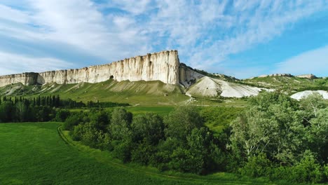 white cliffs and lush green valley landscape