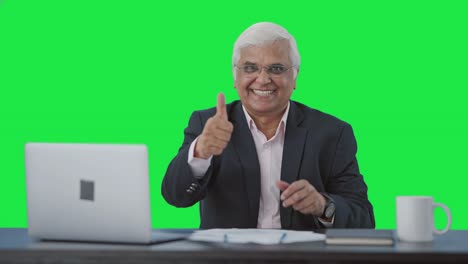 Happy-senior-Indian-businessman-showing-thumbs-up-Green-screen