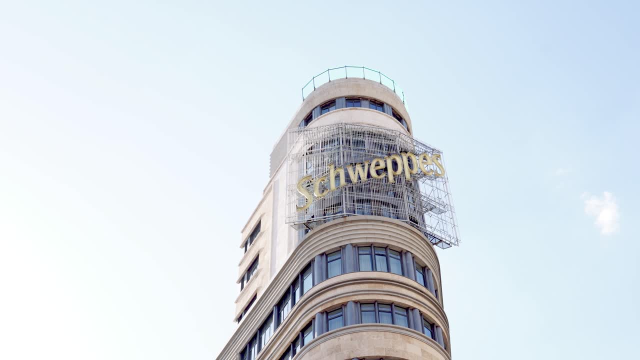 Schweppes sign in Carrión building during a sunny day in Madrid city, Spain