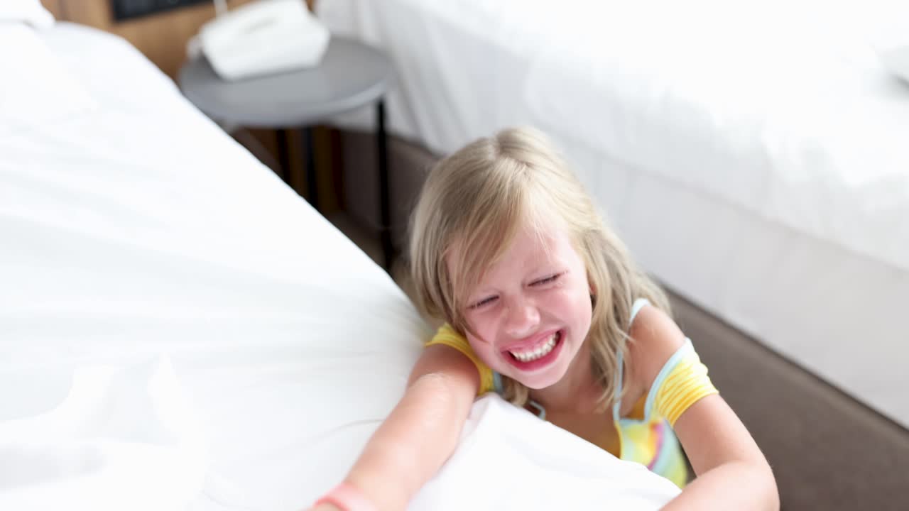 Young girl crying intensely in bed