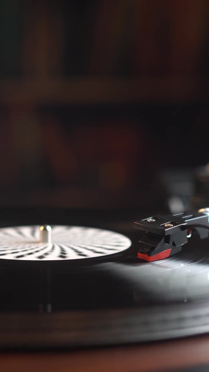 Vista verticale, riproduzione di un disco in vinile che gira su giradischi in un ambiente interno
