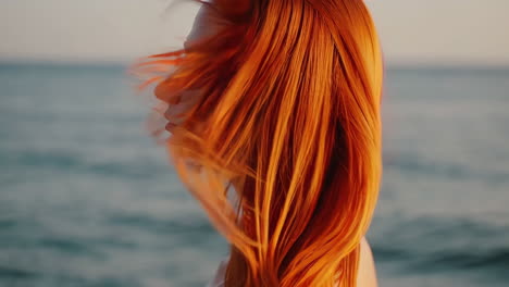woman with red hair at sunset beach