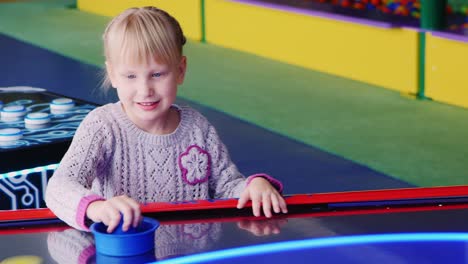 The-child-enthusiastically-plays-table-hockey-3