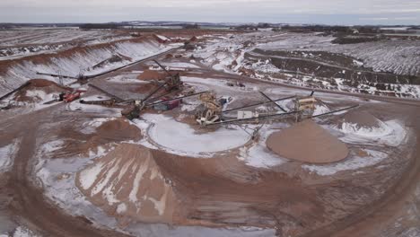 aerial drone view of gravel pit, open quarry with heavy mining machinery