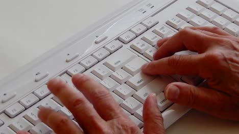 busy hands working and typing on a computer keyboard