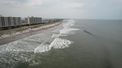 Jersey-shore-drone-beach-ocean-flyover-overcast-summer-day