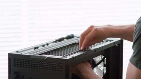 Man-attaching-a-radiator-to-a-computer-case