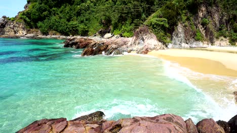 tropical andaman seascape scenic off beautiful beach in thailand with wave crashing on sandy shore