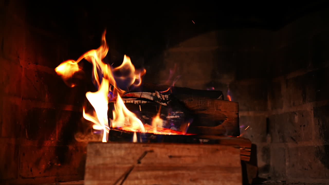 Warm cozy fire in fireplace. Close up firewood coal in the fireplace