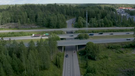 still aerial view of a motorway overpass as two people walk under the bridge