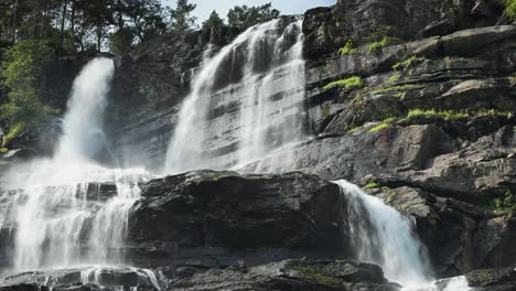 a magnificent tvindefossen waterfall in summer