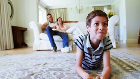 Parents-and-son-watching-television-in-living-room