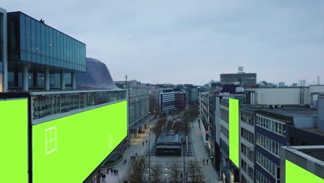 Evening-fly-above-shopping-boulevard-in-city-centre-at-twilight.-Chroma-key-building-surfaces-for-adding-your-content.-Frankfurt-am-Main,-Germany