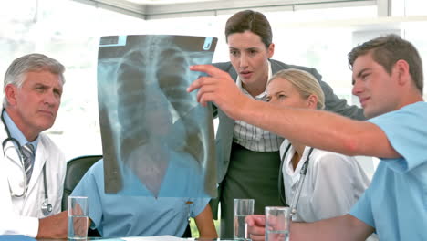 Medical-team-looking-at-Xray-during-meeting-